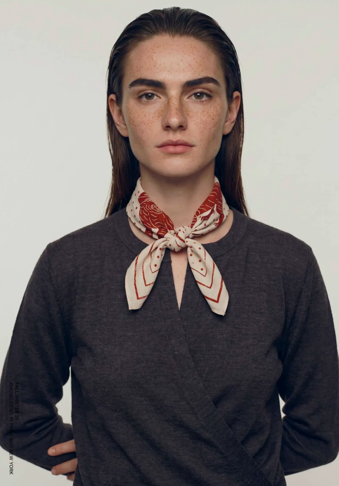 Charcoal wrap knit styled with a printed red and cream silk scarf.