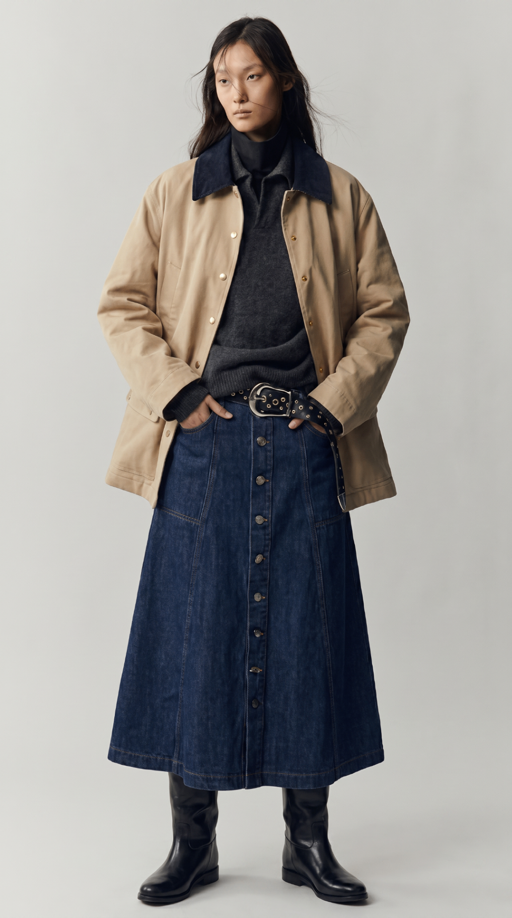 Look 03 — beige jacket with a dark collar over a charcoal knit and button-front denim skirt.